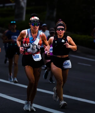 Two runners keeping pace together in a road race.